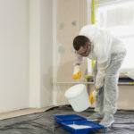 full shot man pouring paint 1
