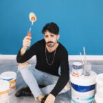man with paint materials